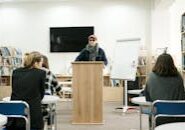 This <a href="https://www.pexels.com/photo/woman-in-black-and-white-jacket-sitting-on-chair-6981110/">Photo</a> was taken by <a href="https://www.pexels.com/@mikhail-nilov">Mikhail Nilov</a> on Pexels.