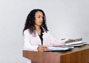 This <a href="https://www.pexels.com/photo/woman-at-podium-8730757/">Photo</a> was taken by <a href="https://www.pexels.com/@mikhail-nilov">Mikhail Nilov</a> on Pexels.