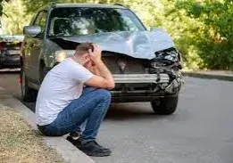 a man sitting next to accidental car